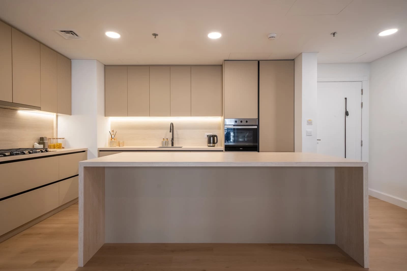 Beige neutral kitchen with warm minimalism in Jumeirah Golf Estates apartment