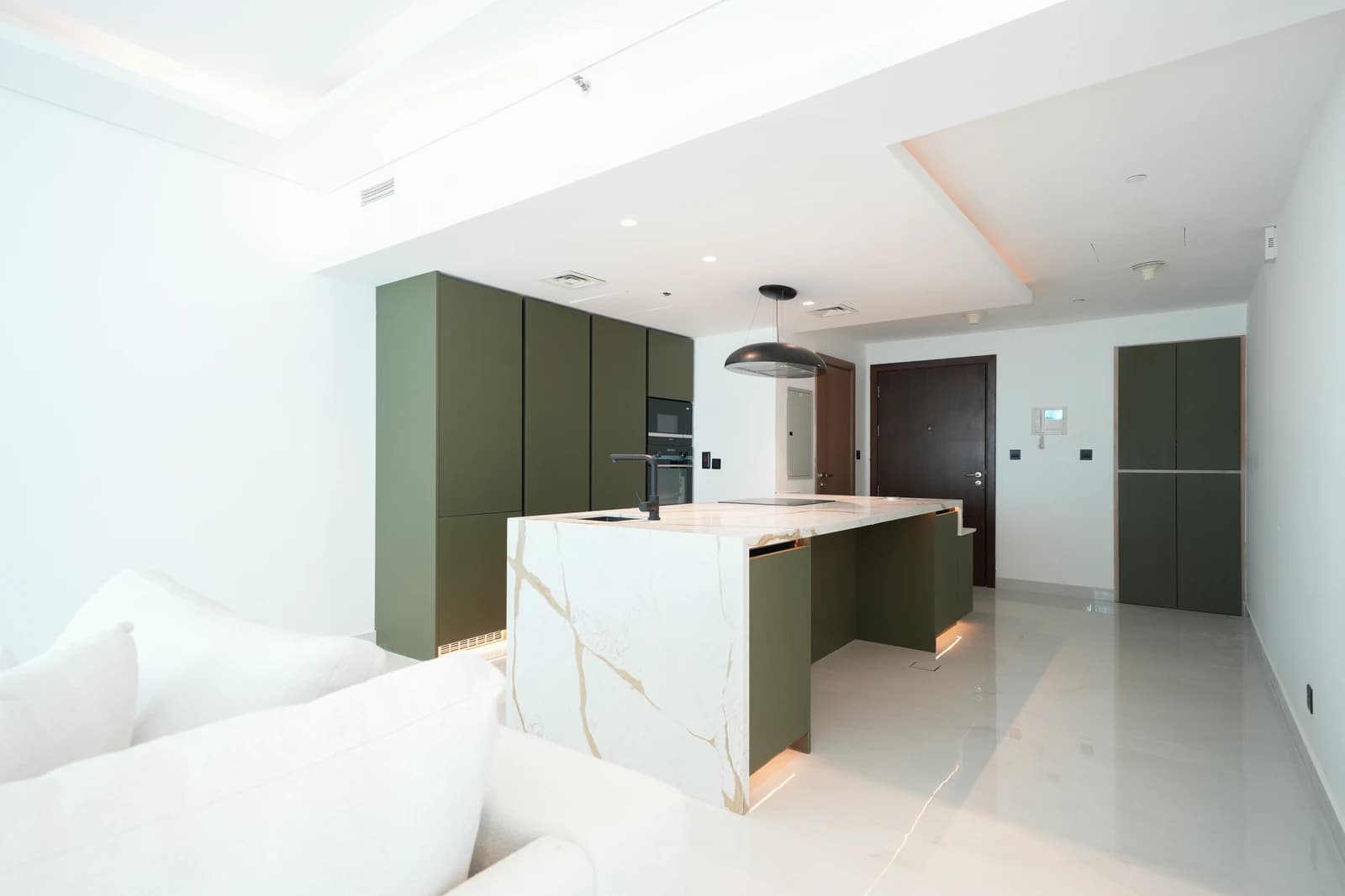 Sage green kitchen with marble waterfall island in Park Island Dubai Marina